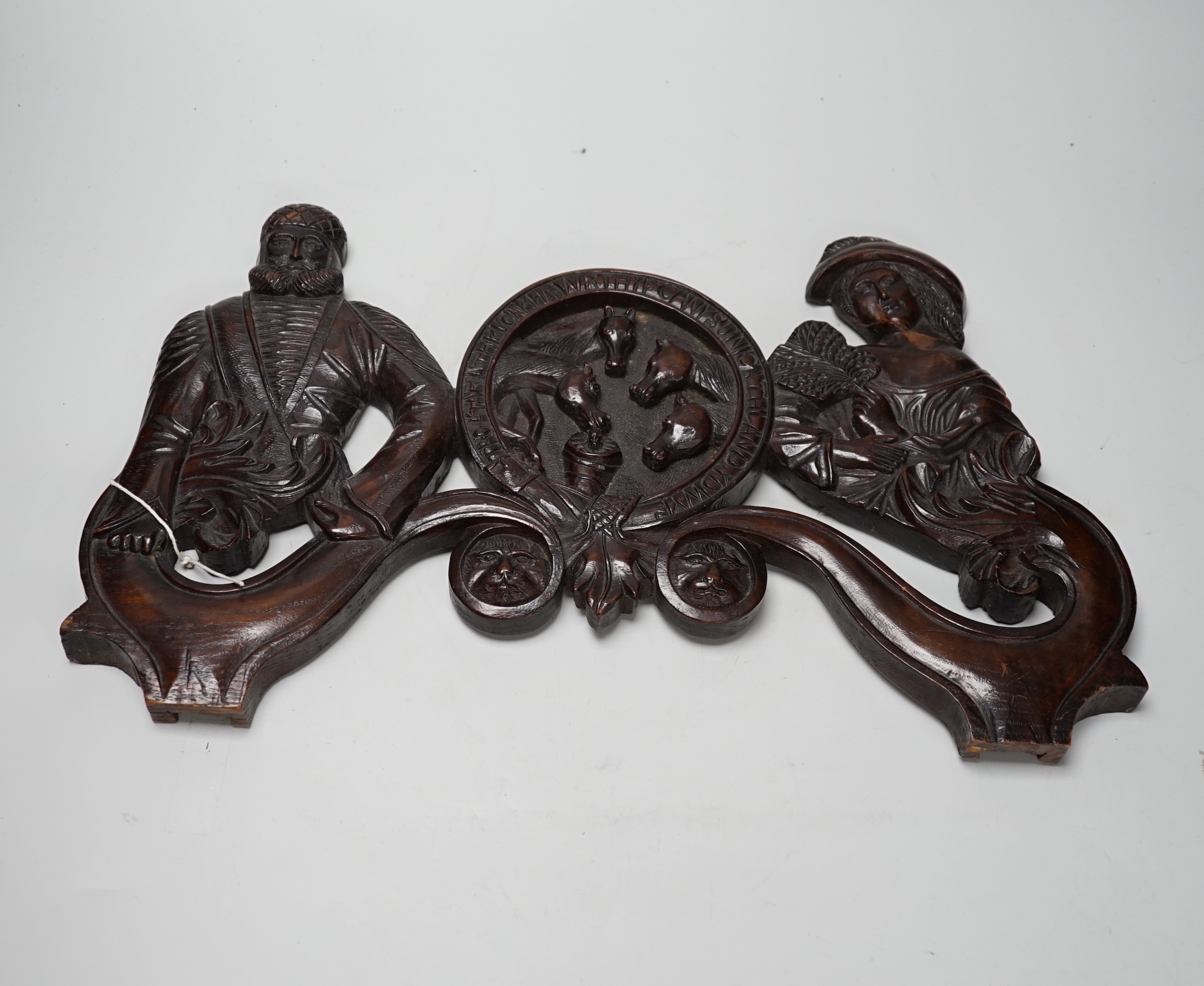 A 19th century carved figural door pediment, 46cm wide